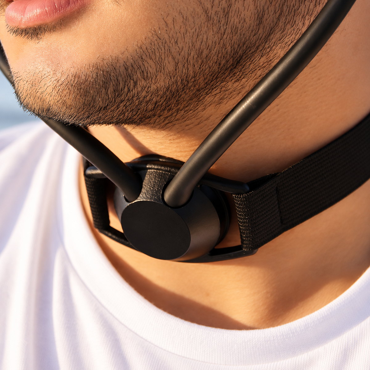 Person wearing Inpulse, showing the chamber at the base of the throat and the acoustic path to the ears.