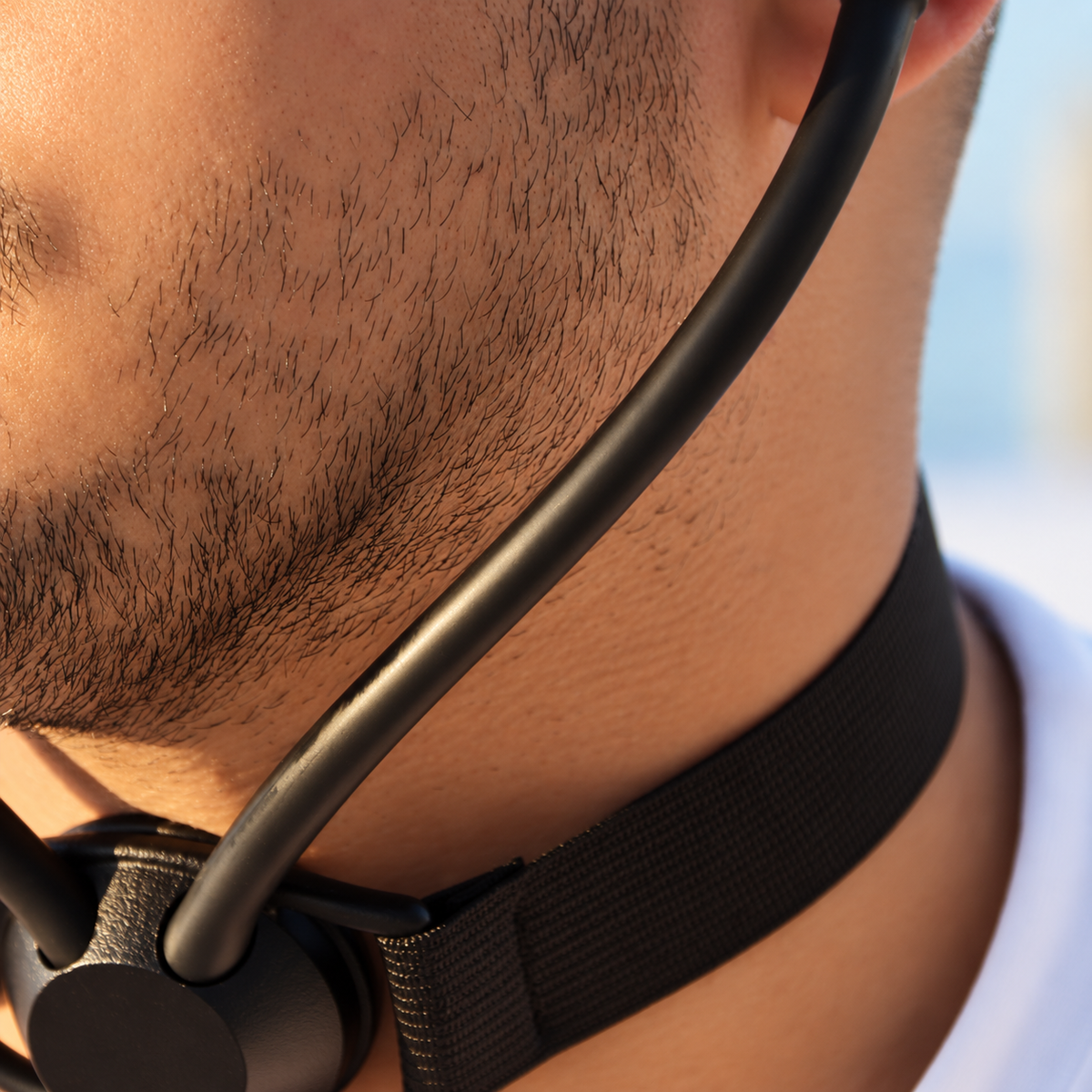 Person wearing Inpulse, showing the chamber at the base of the throat and the acoustic path to the ears.