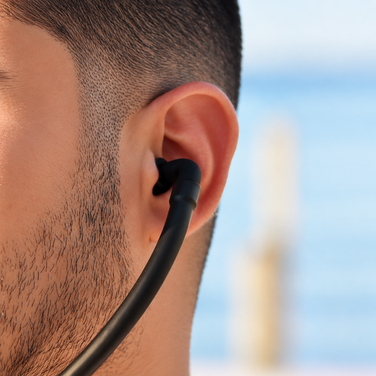 Person wearing Inpulse, showing the chamber at the base of the throat and the acoustic path to the ears.