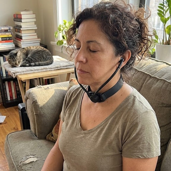 Woman using Inpulse during a seated meditation at home.