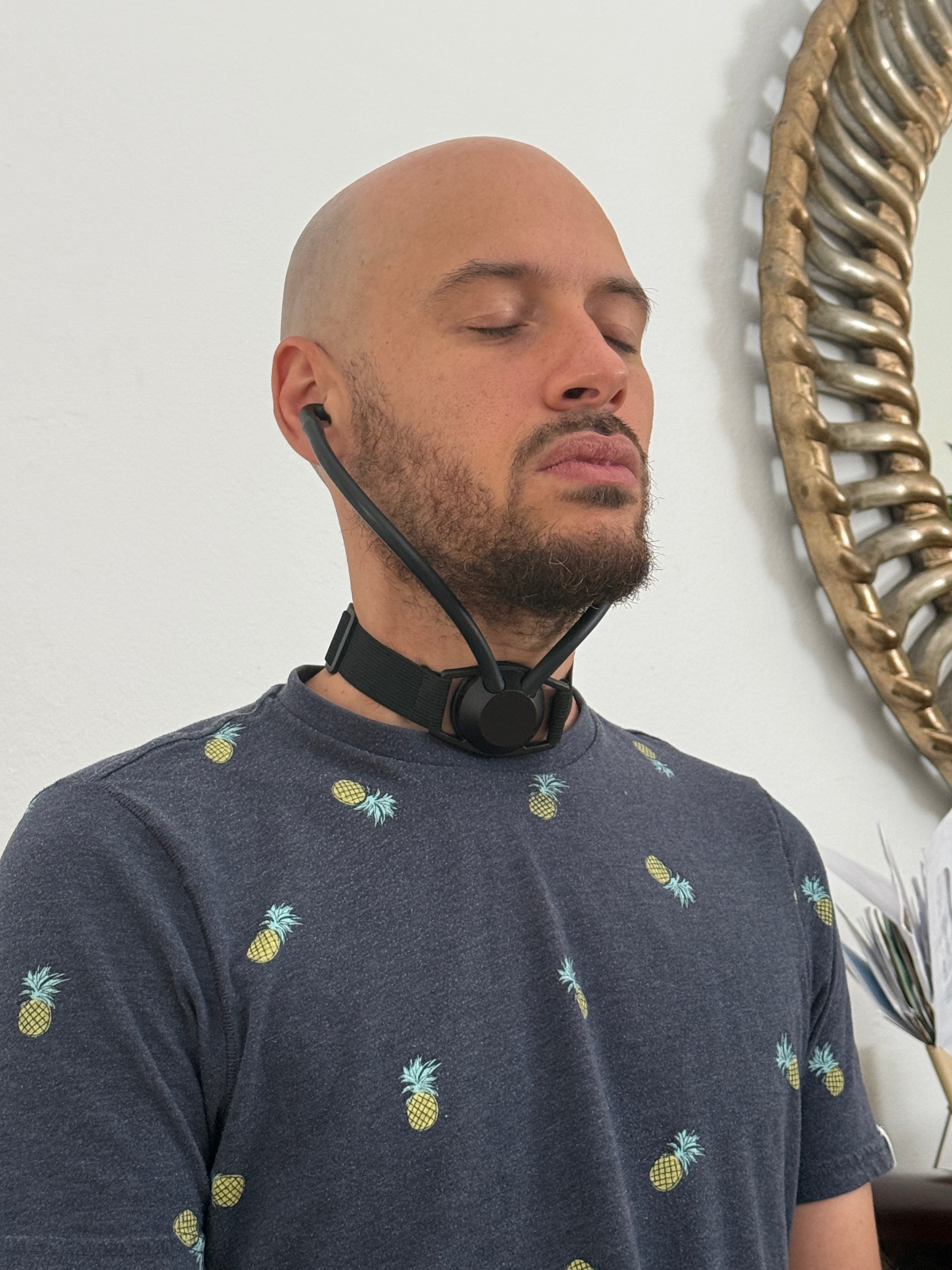Man wearing Inpulse while seated with his eyes closed